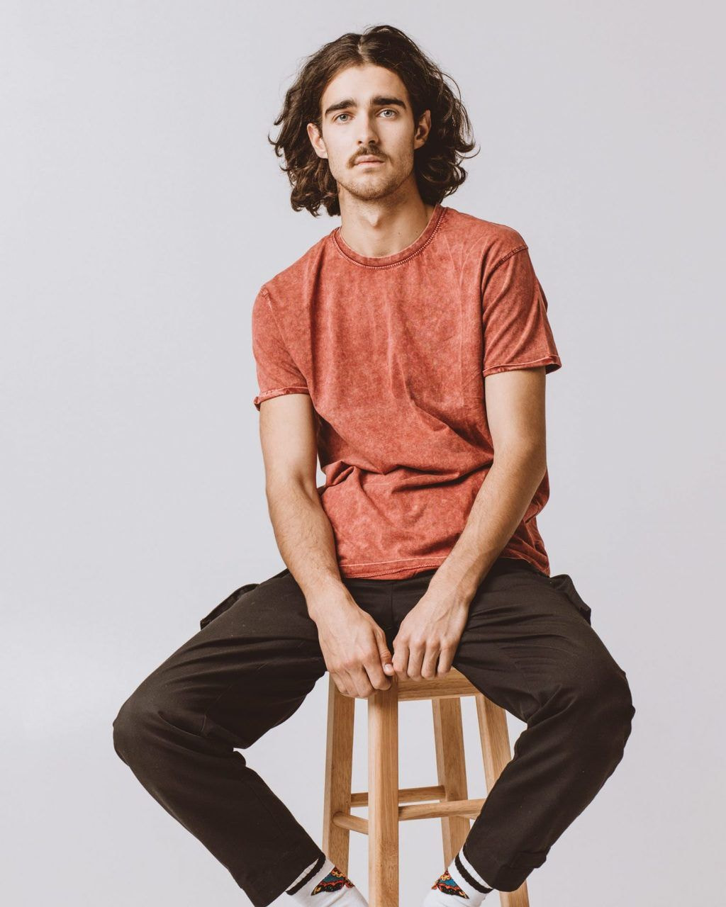 a man wearing an orange custom T-shirt