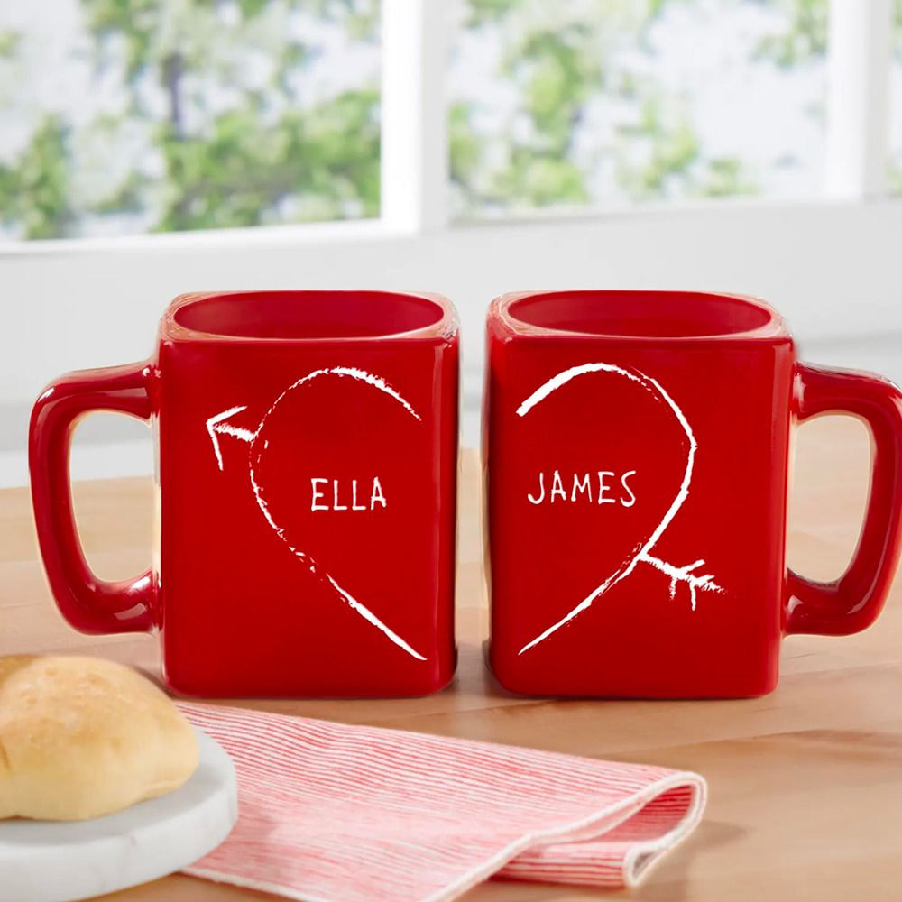 two red mugs with white writing on them