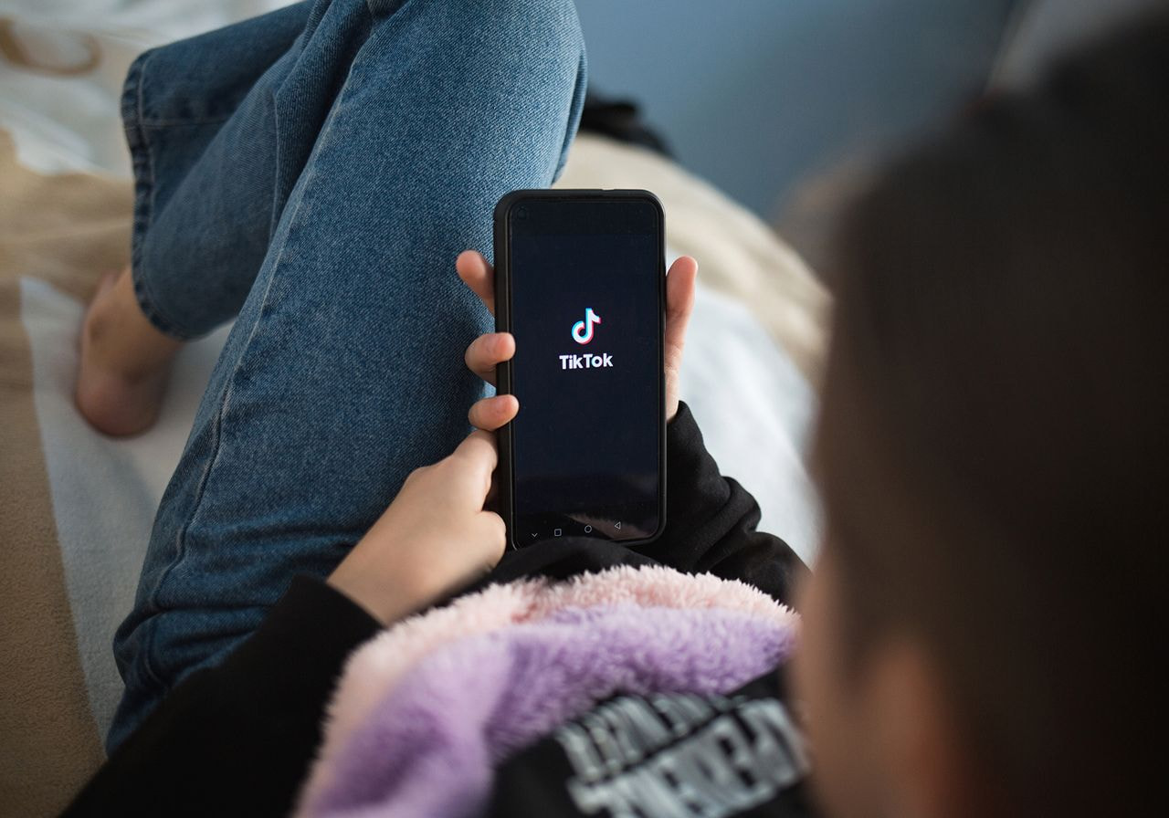 A person is opening the TikTok app