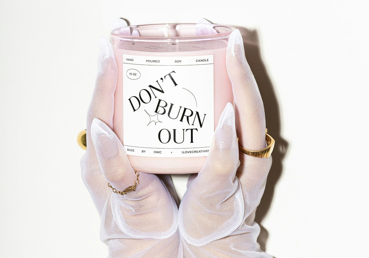 A person holding a lit candle with the phrase "don't burn out" displayed prominently.