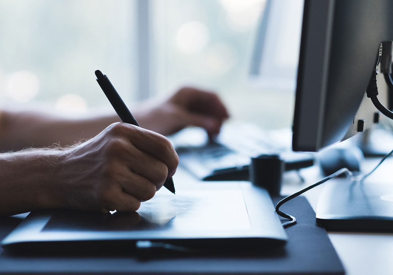 A person using a tablet to draw