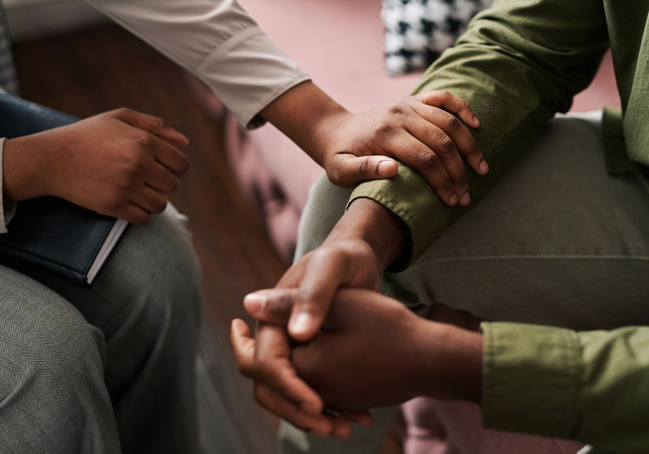 One person comforting another.