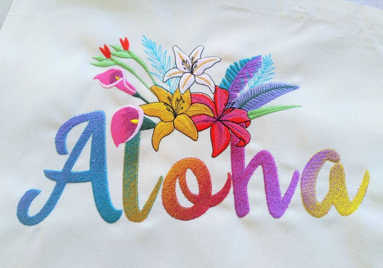 A tote bag featuring the word "aloha" prominently displayed on its surface.