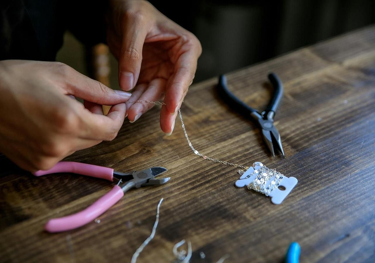 A Person making a necklace.