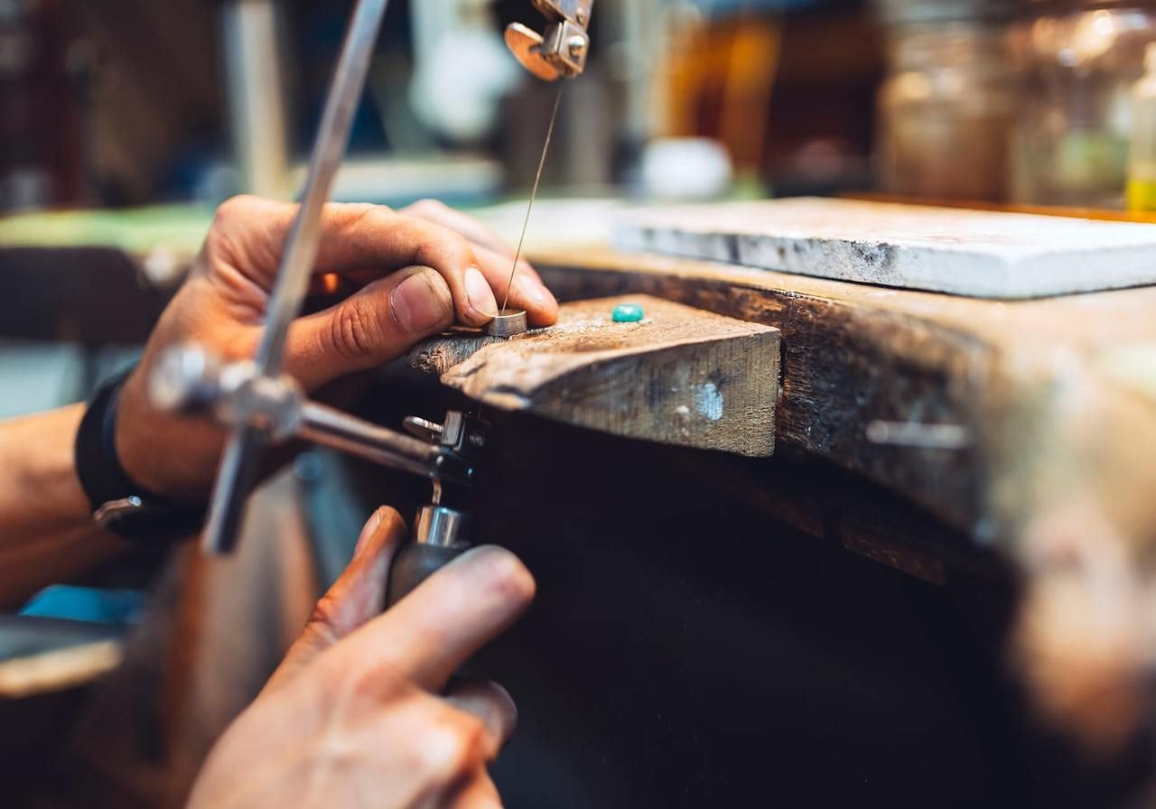 A person is shaping a ring with tools.