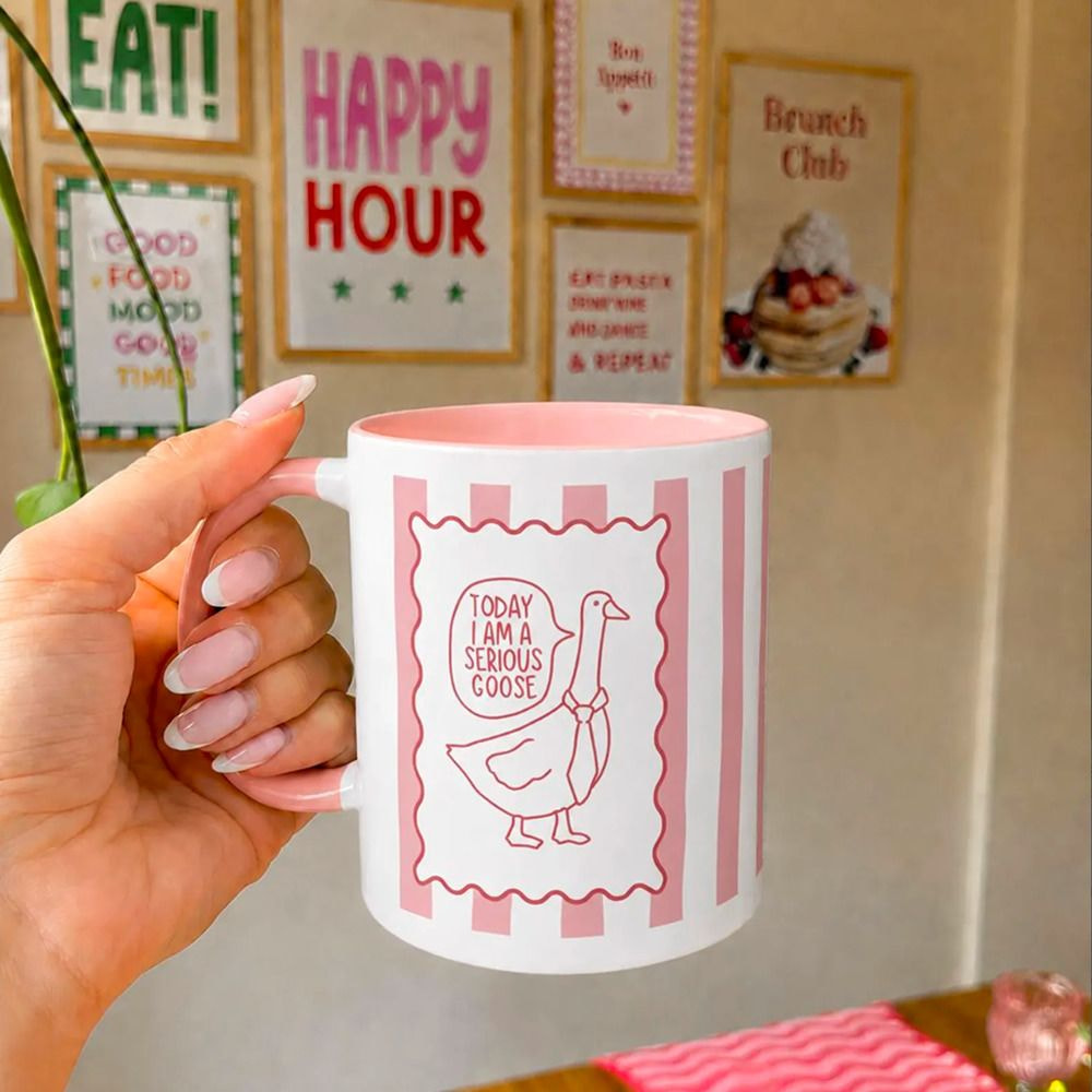 a hand holding a mug