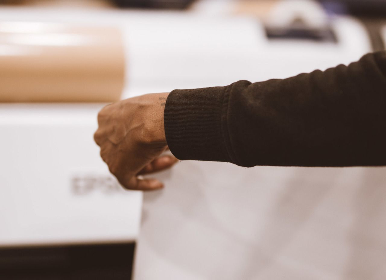 photo of a hand holding up archival paper