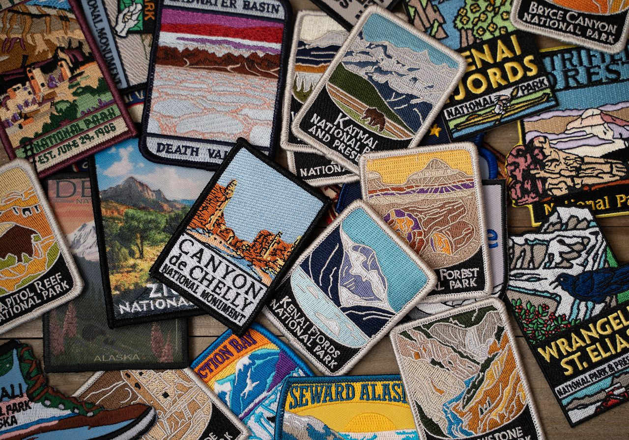 A variety of fabric patches featuring unique designs and colors arranged together on a flat surface.