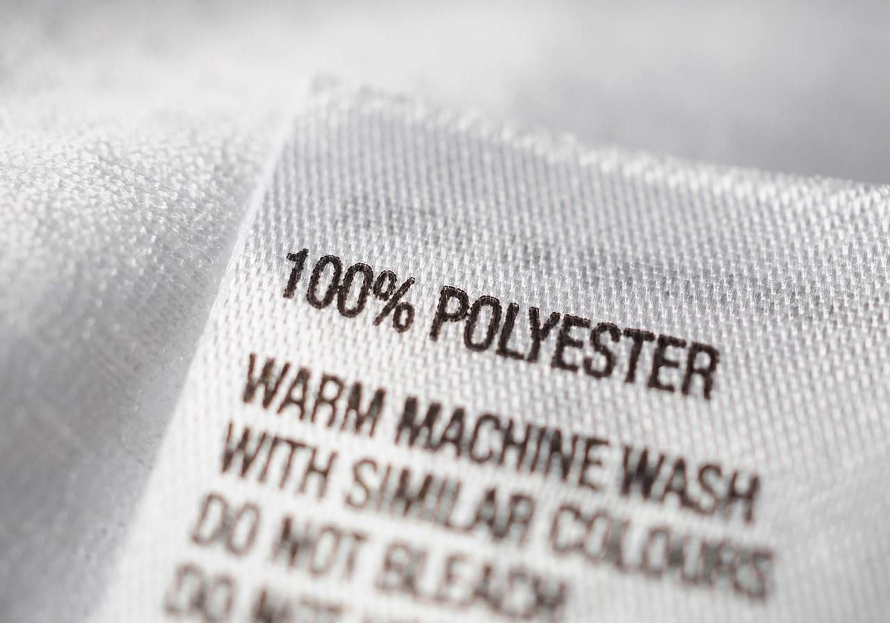 A product tag with “100% polyester”.