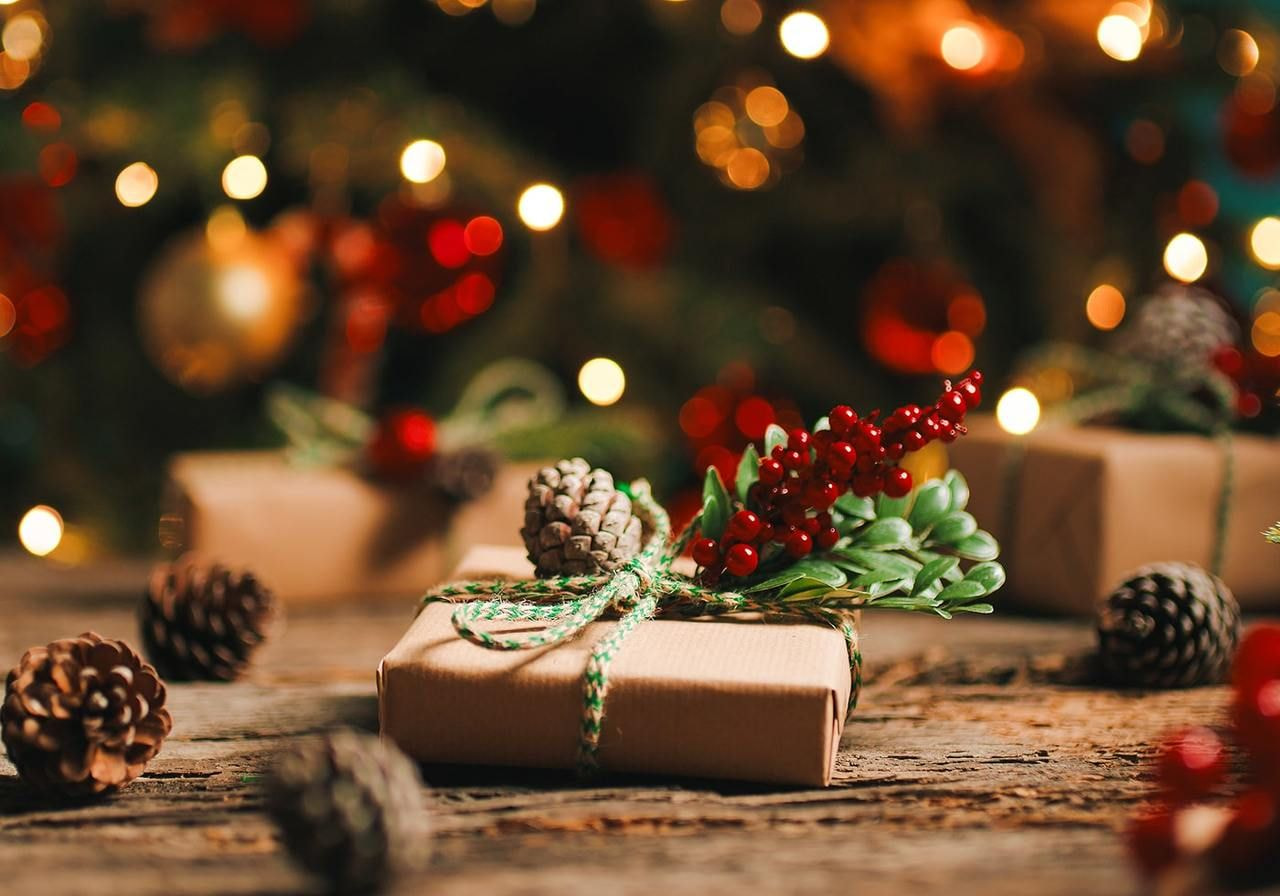 A nicely wrapped Christmas gift in a cosy setting.