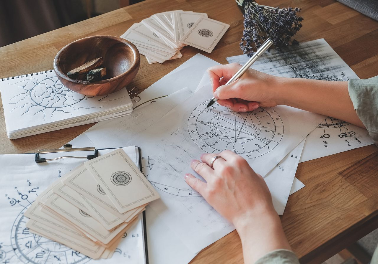 A person drawing an astrology map.