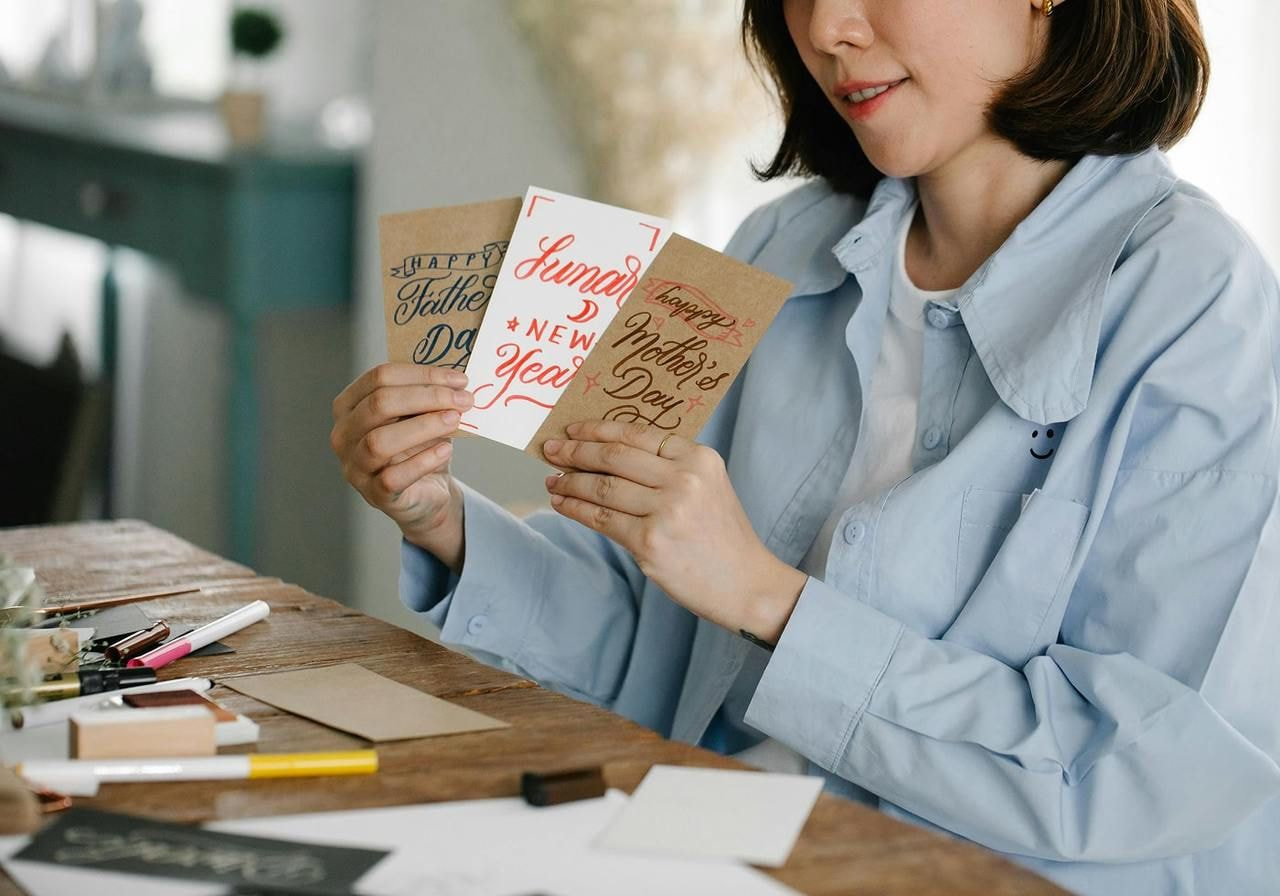 Person showing greeting cards.