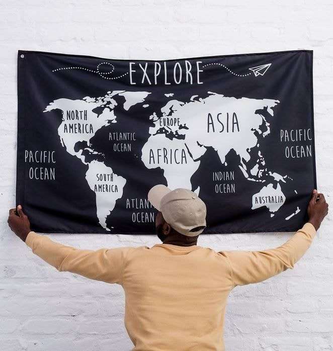 A man hanging a custom flag on the wall