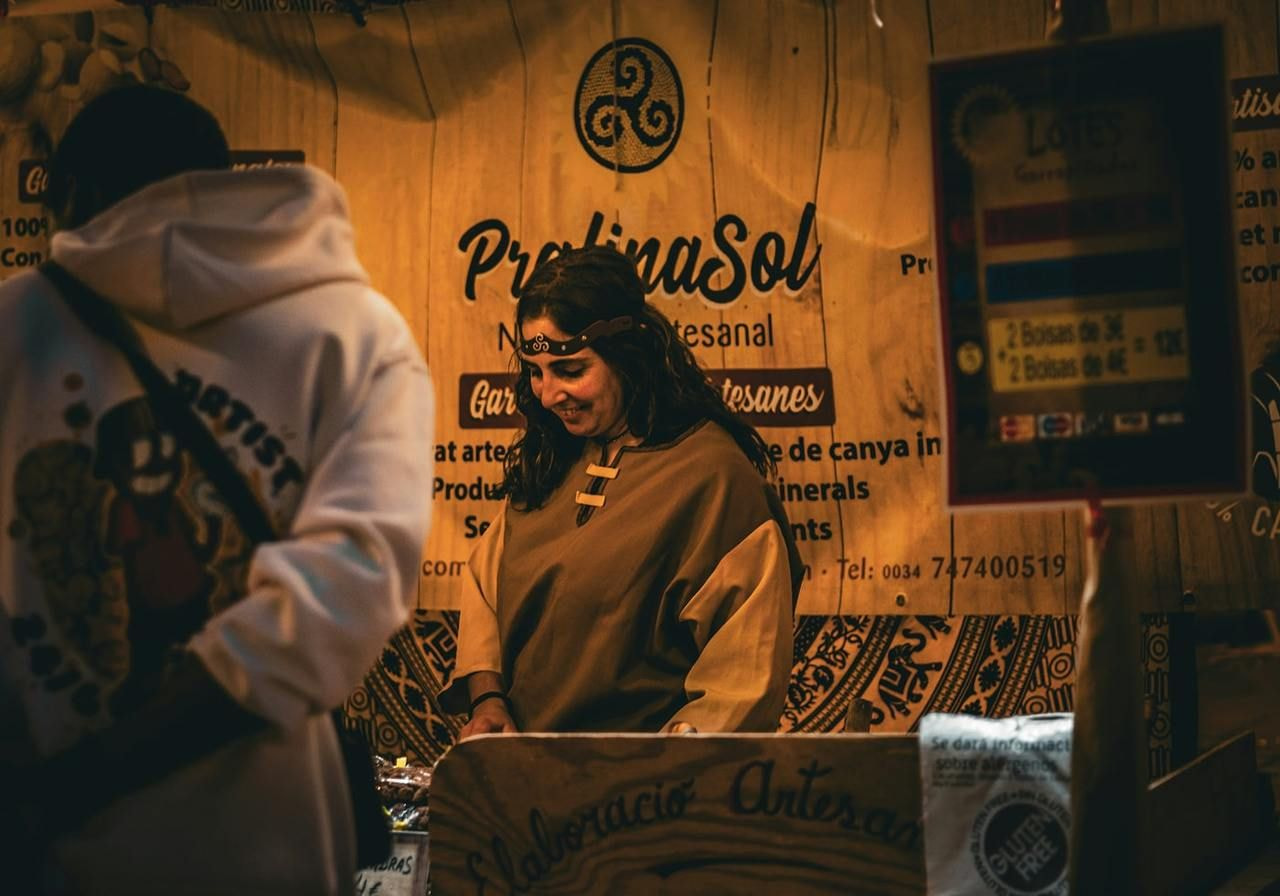 A smiling woman selling personal brand products.