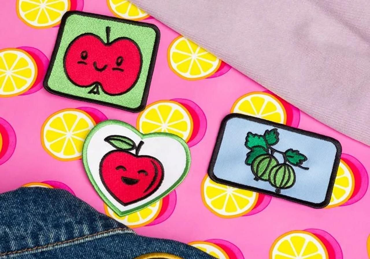 Multiple fruit-themed colourful embroidery patches.