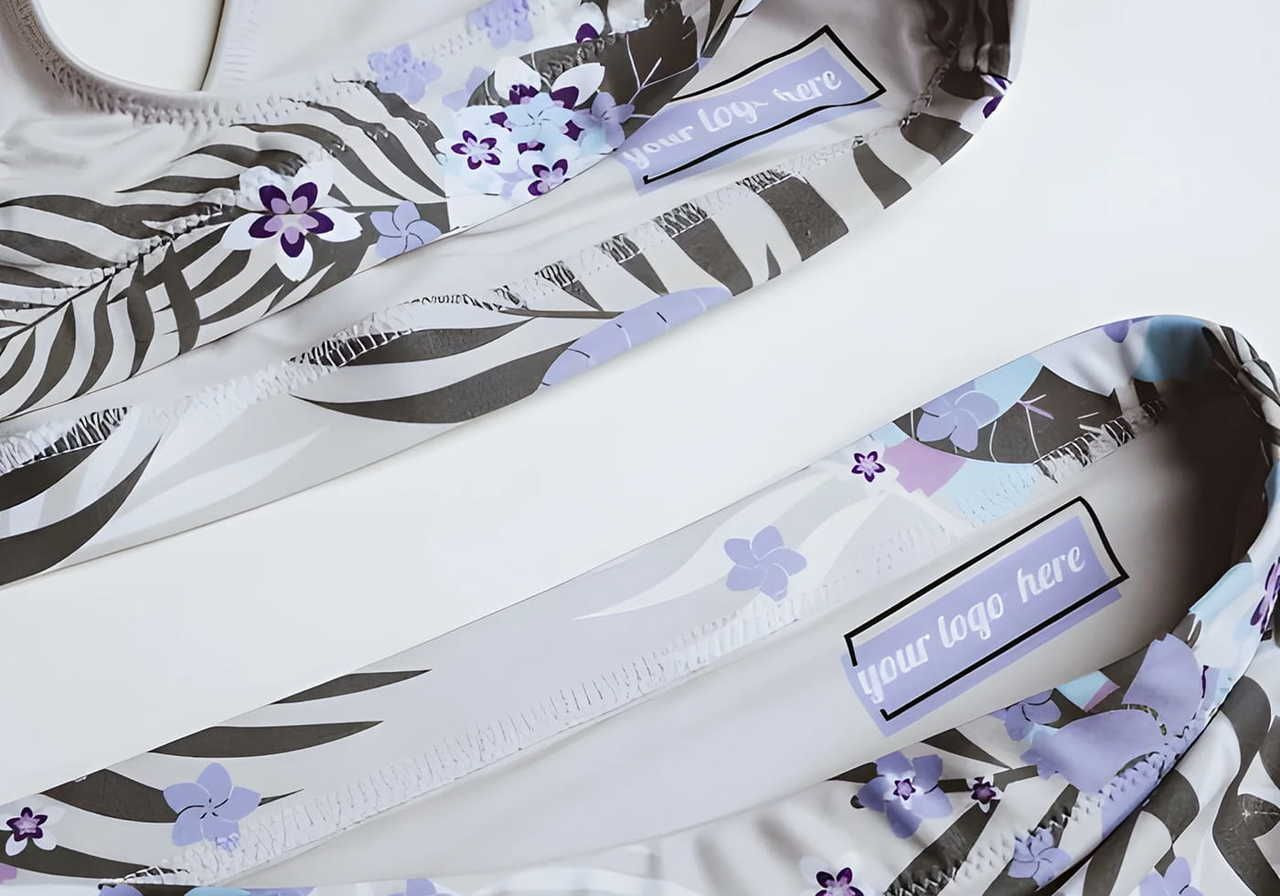 Yoga pants and top with a floral and zebra print design in purple, lilac, and black. "Your logo here" inside label is visible.