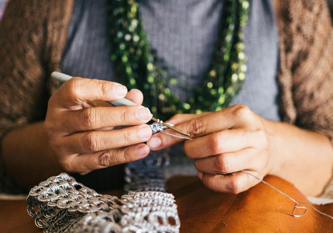 A person knitting.