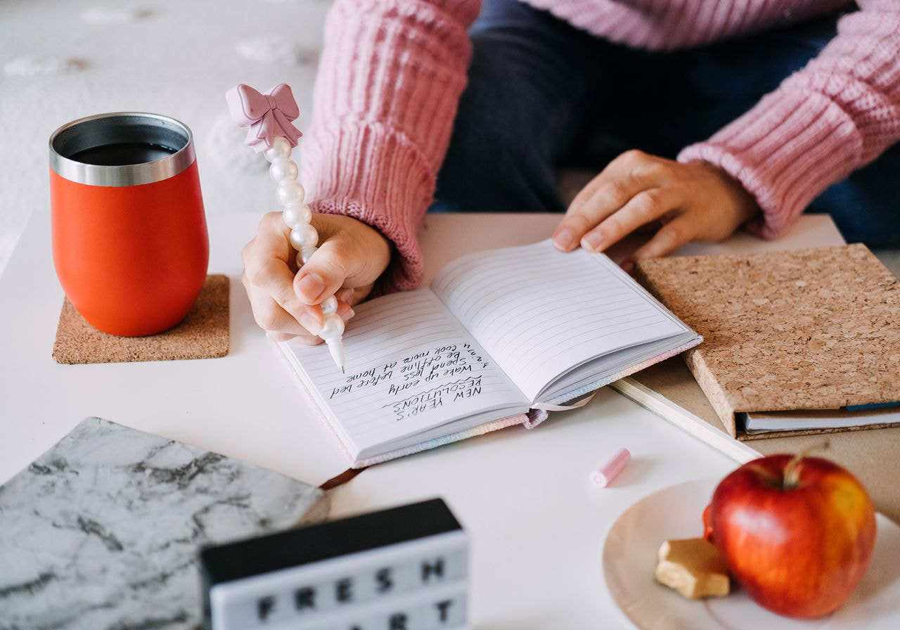 A person is journaling in a notebook.
