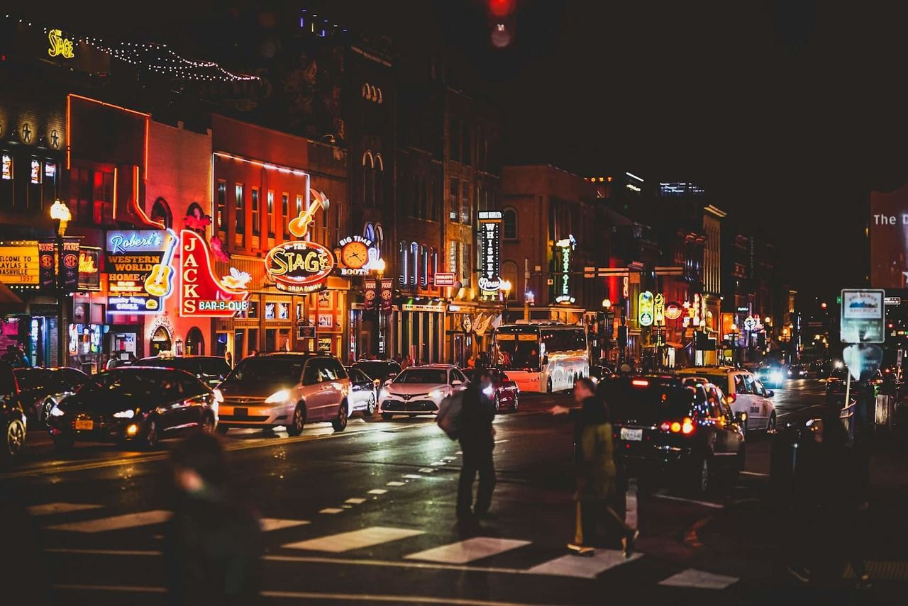 a city street with cars and people