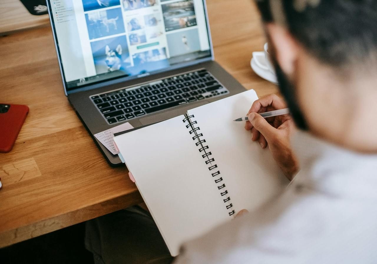 Person writing notes in a notebook.