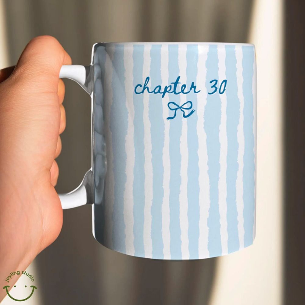 a hand holding a mug