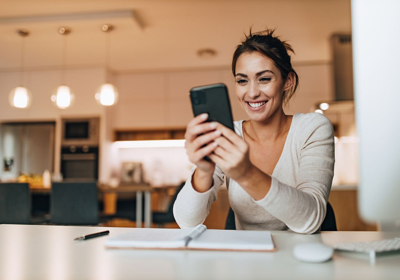 A woman is scrolling on her phone