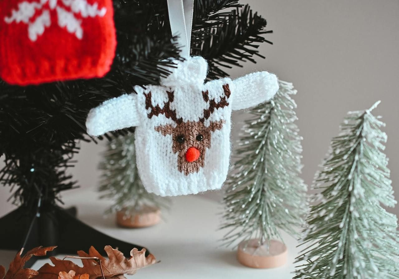 Colorful knitted Christmas tree decorations in Christmas sweater shape.