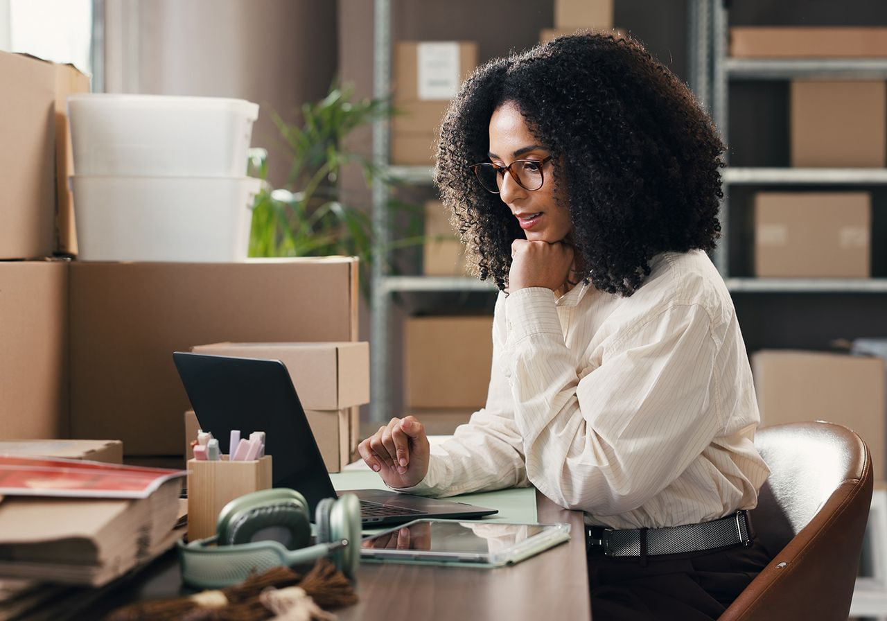 A woman is working on a laptop.