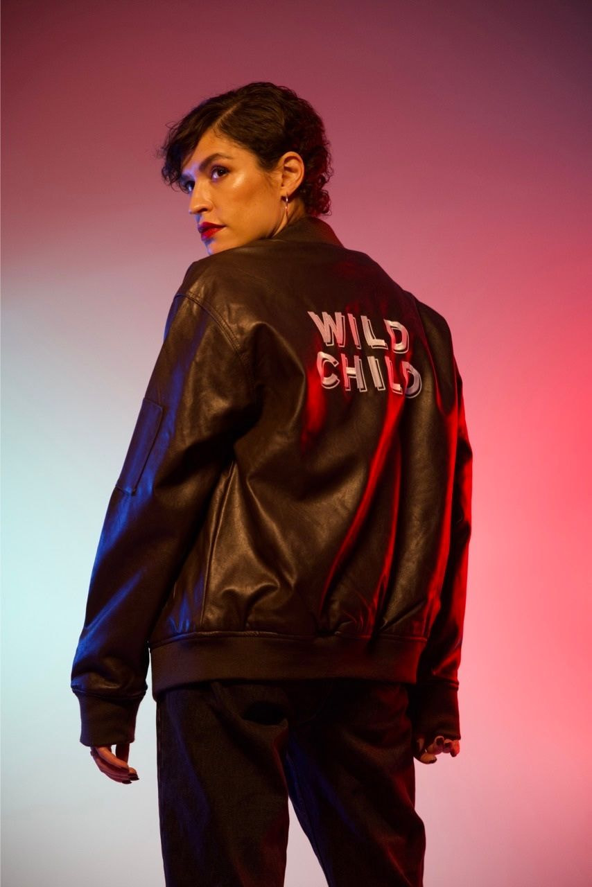 woman wearing an embroidered faux leather jacket