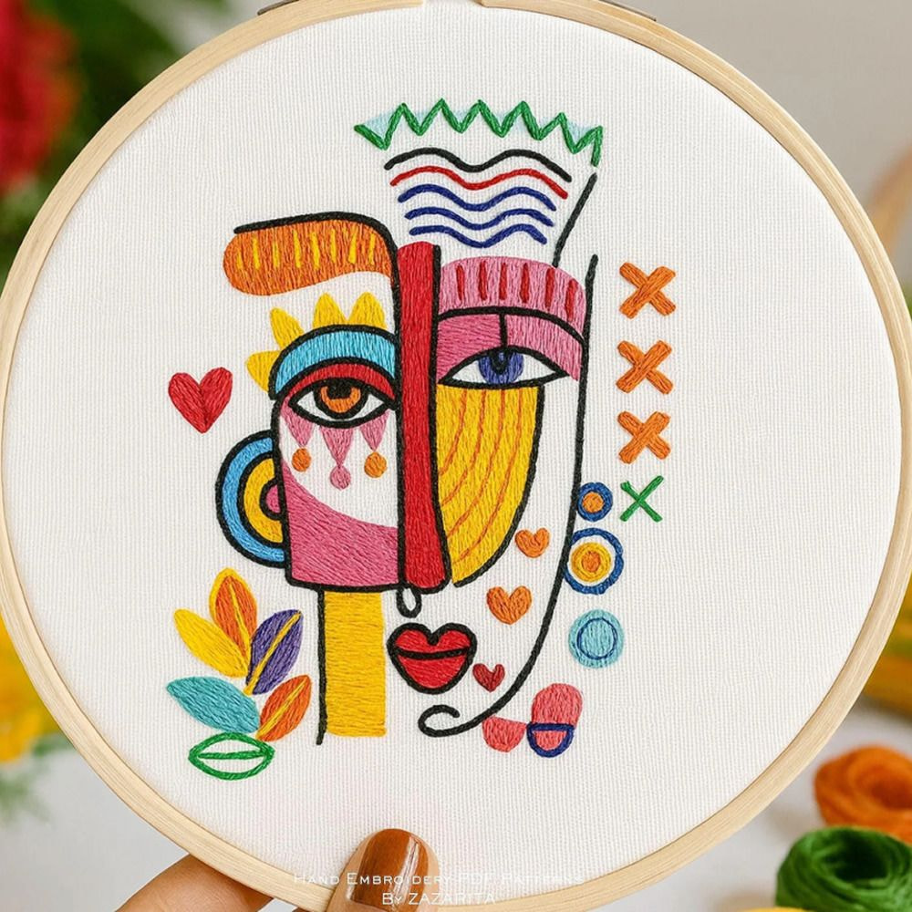 A vibrant embroidery design featuring a smiling face surrounded by a heart motif in various colors.
