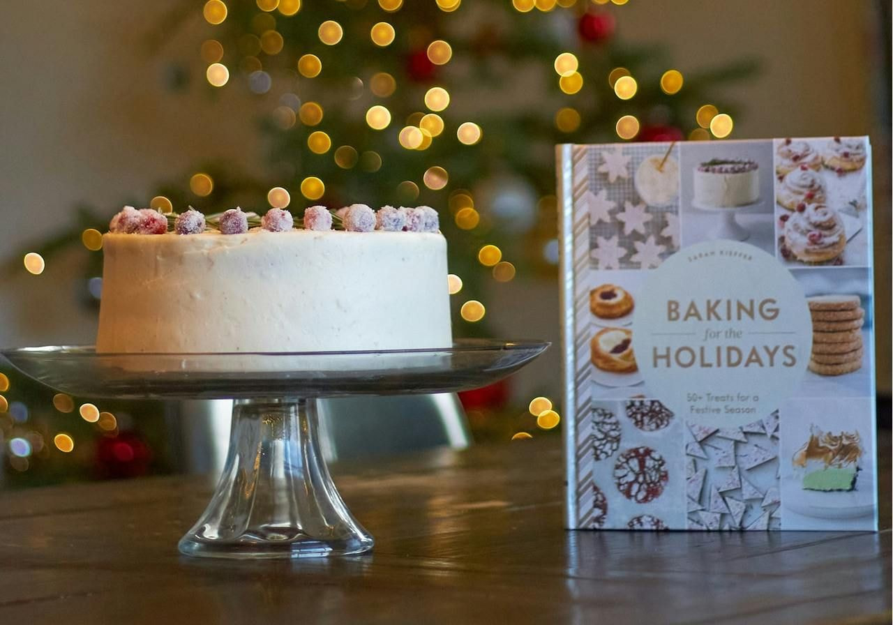 A cake on a table beside an open book, creating a cozy atmosphere for a celebration or reading session.