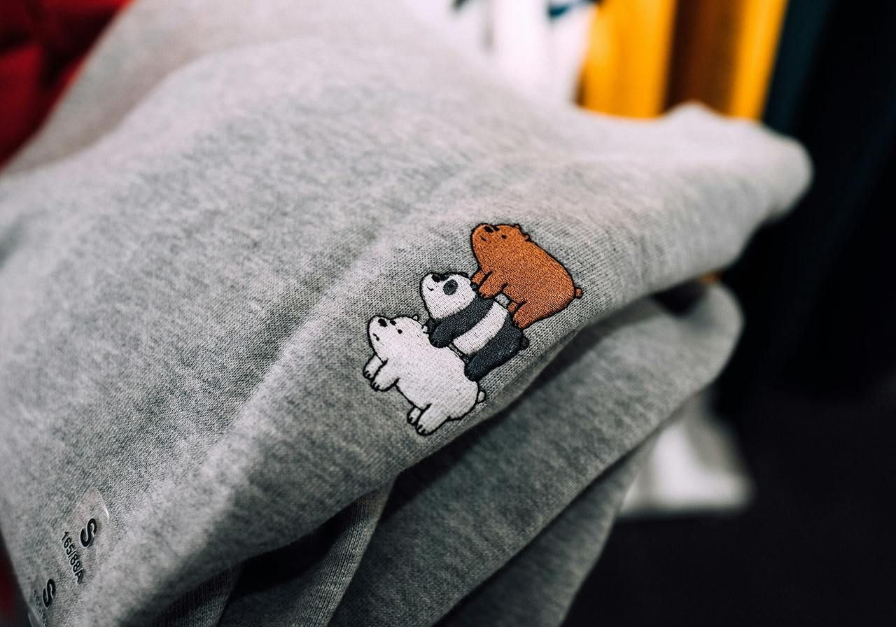 A grey sweatshirt with three illustrated bears embroidered.