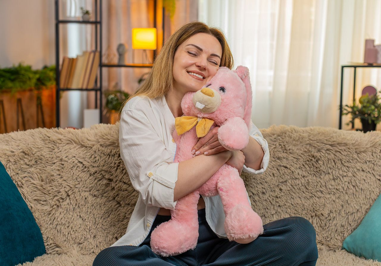 A woman is hugging a plush toy.