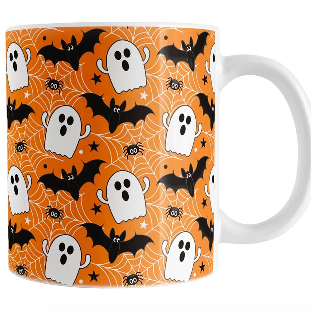 a mug with ghosts and bats on it