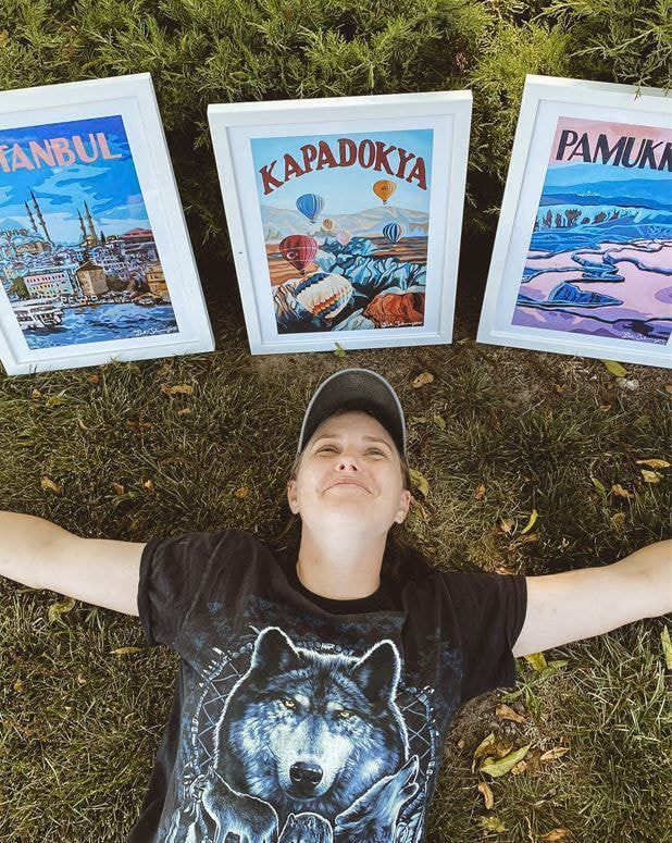 A woman with custom posters with art
