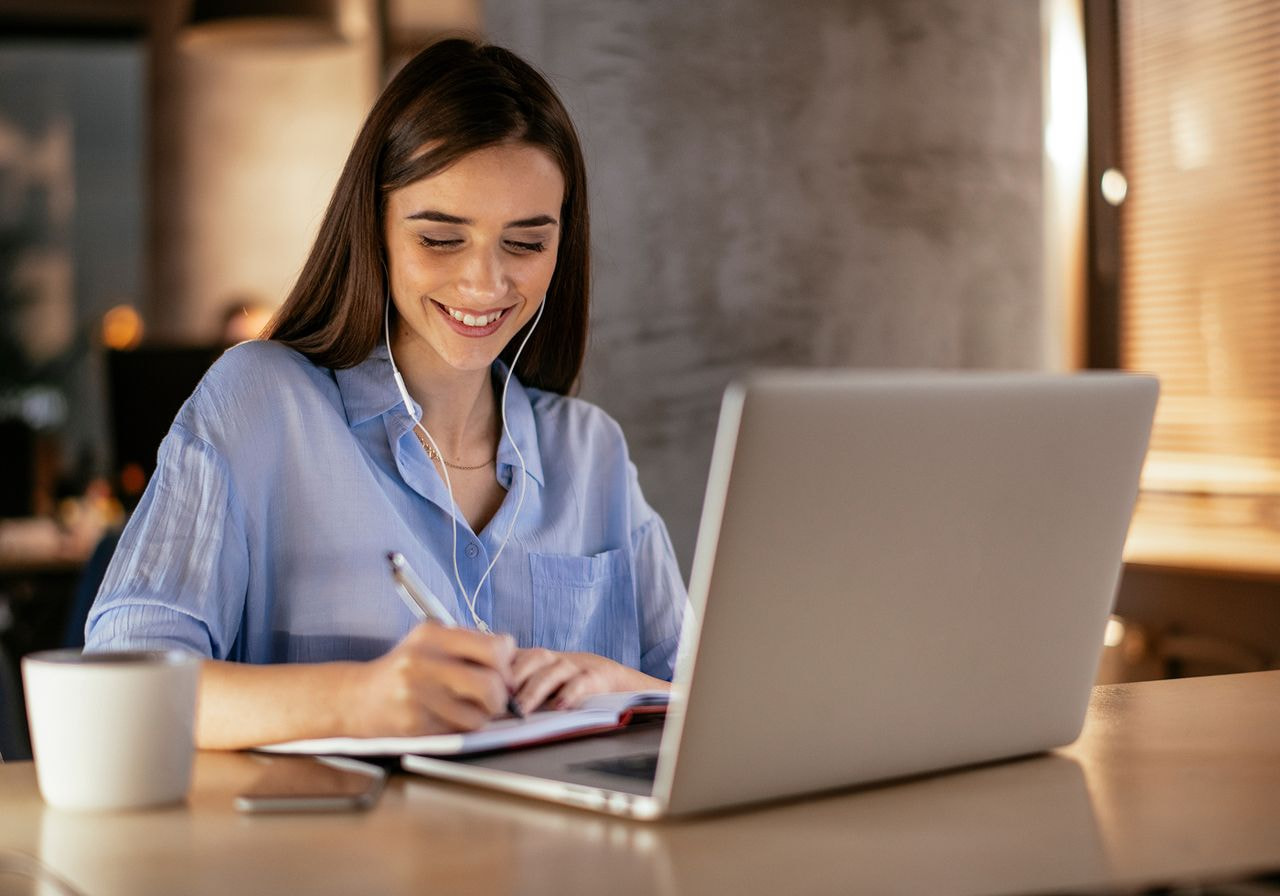 A woman is working on her laptop