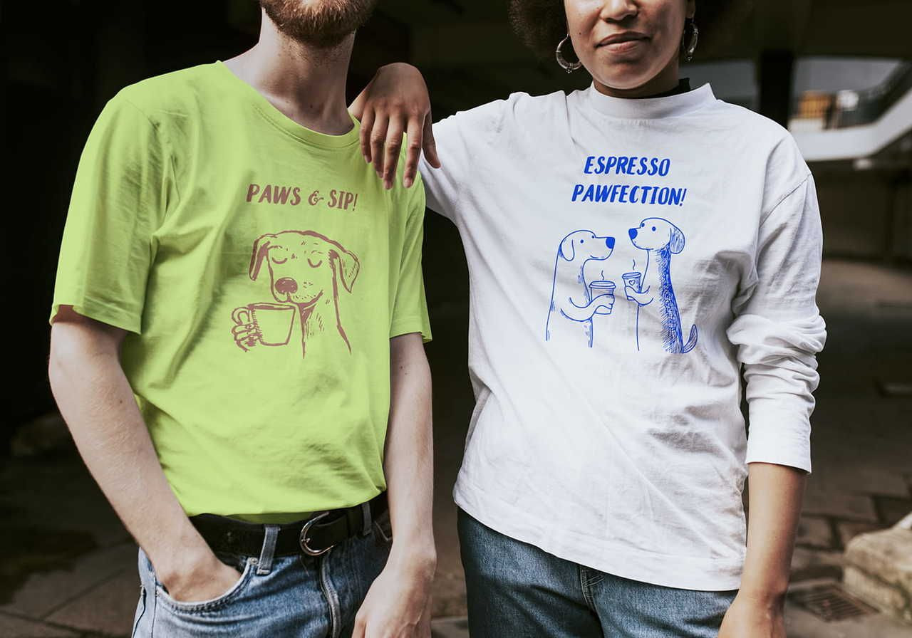 Two people stand side by side, each wearing a graphic tee with illustrated dogs and coffee-themed humor.