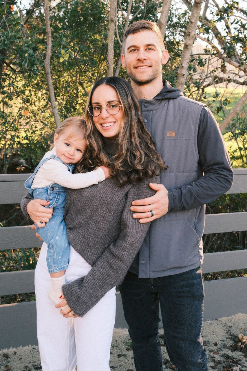 a man and woman holding a child