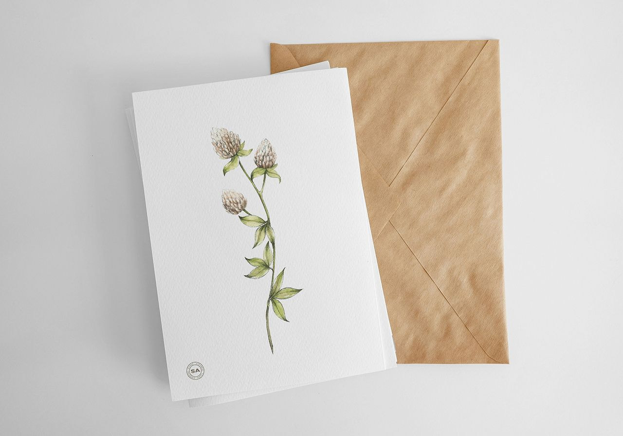 A greeting card featuring a colorful drawing of a flower on the front cover.