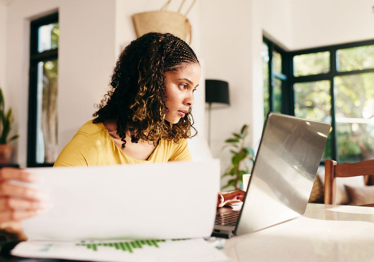 A woman is working on a laptop