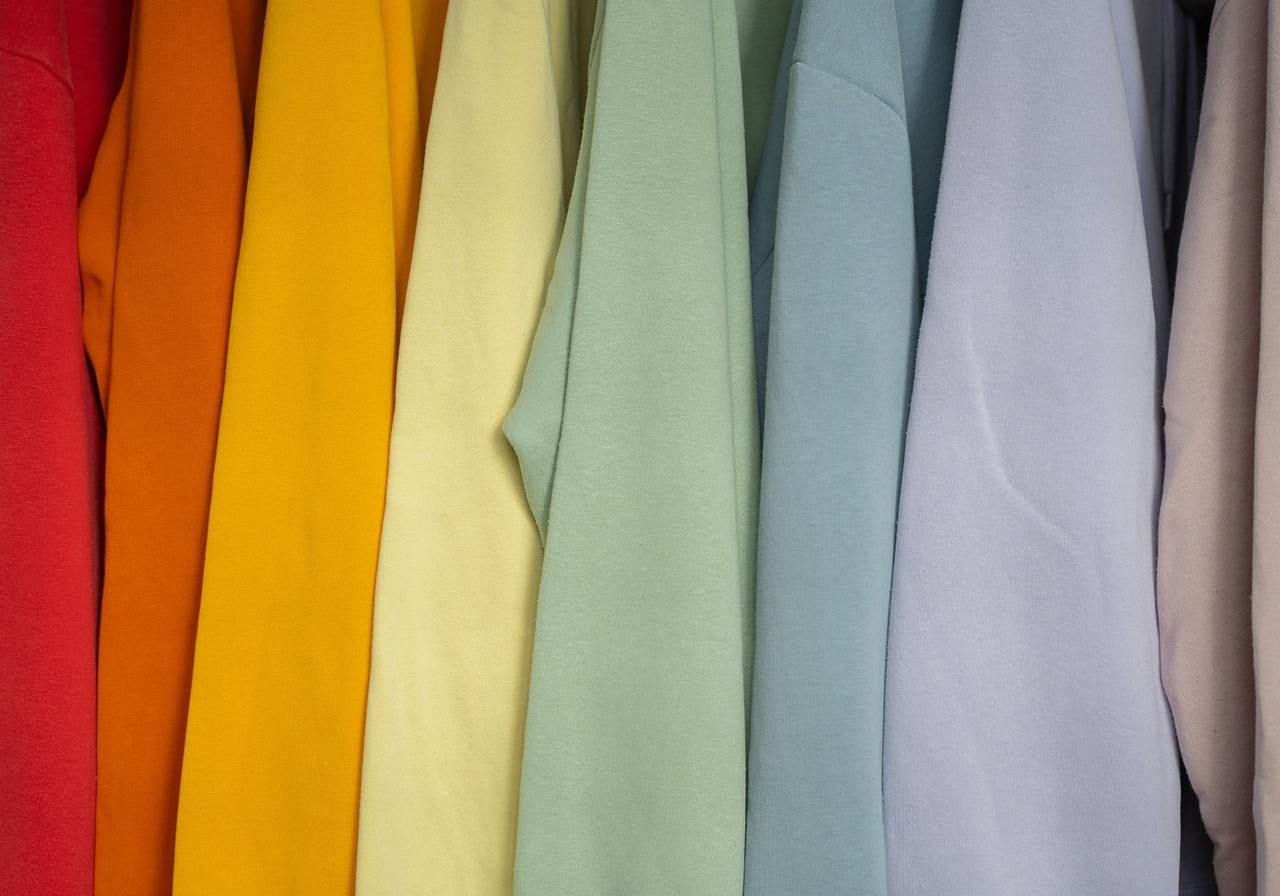Polyester apparel in different colors on hangers.