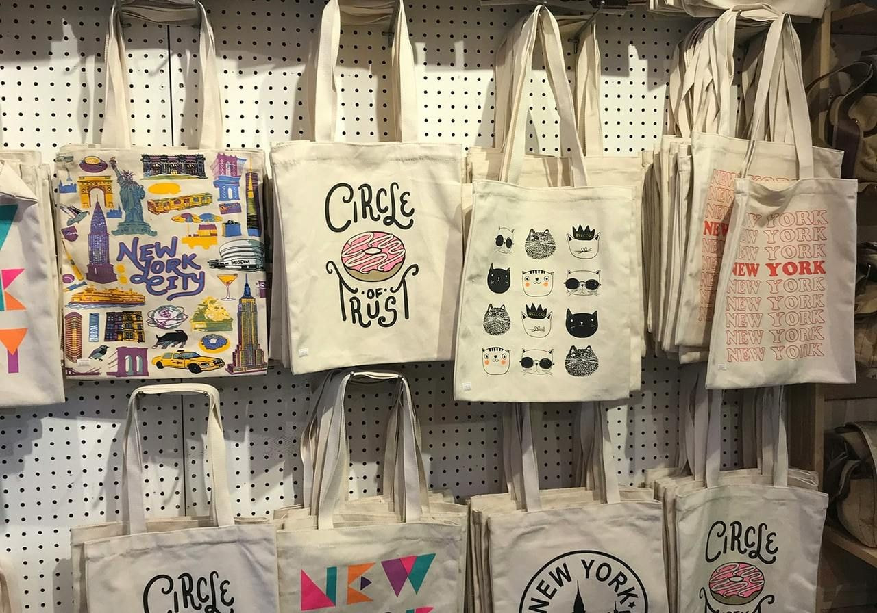 Tote bags hanging on a wall.