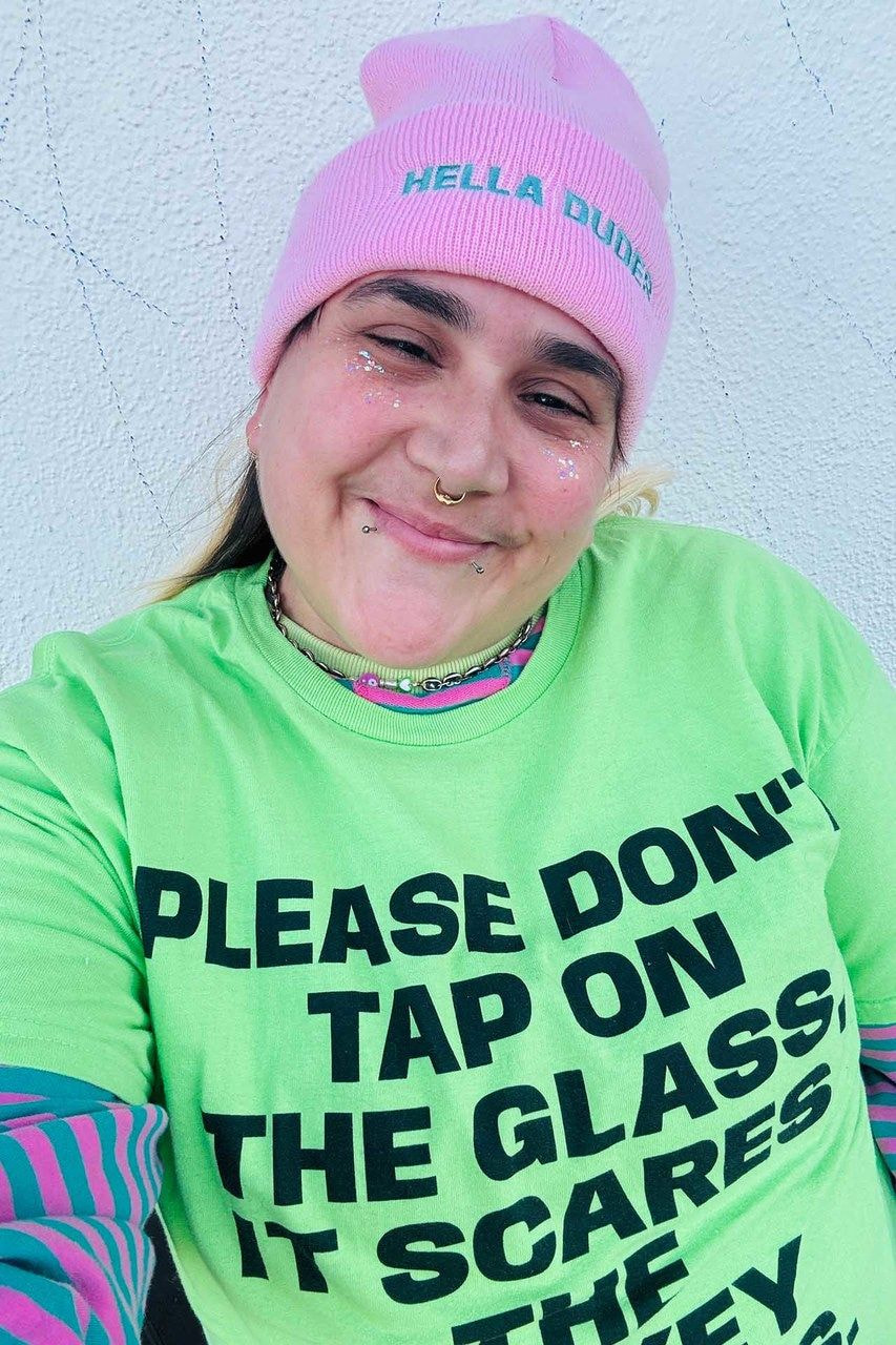 a woman wearing a pink hat and green shirt