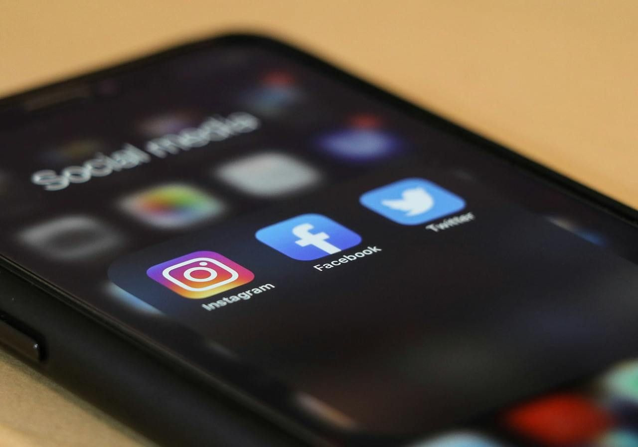 Social media apps on the phone screen.