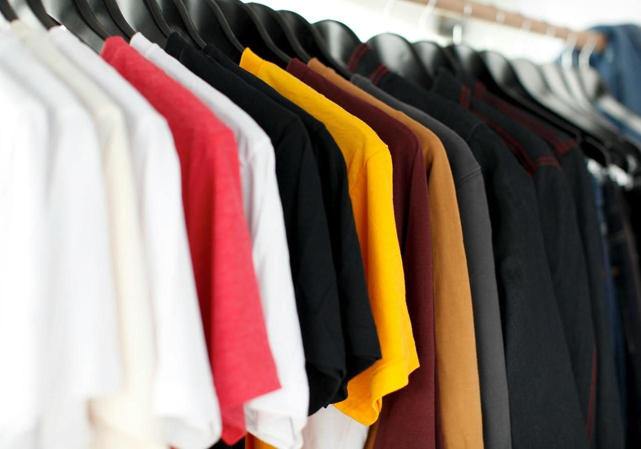 T-shirts in different colors on hangers.