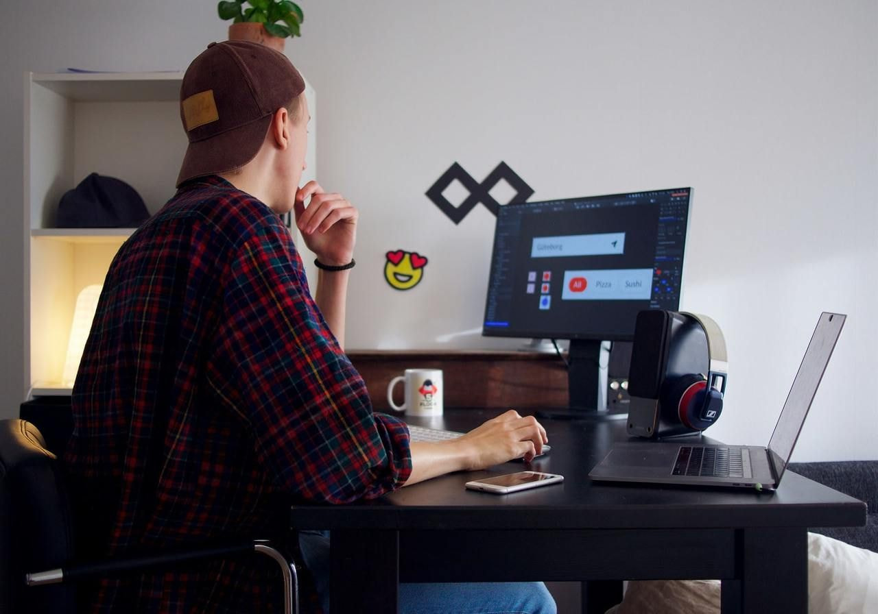 A man is creating visual elements for branding.