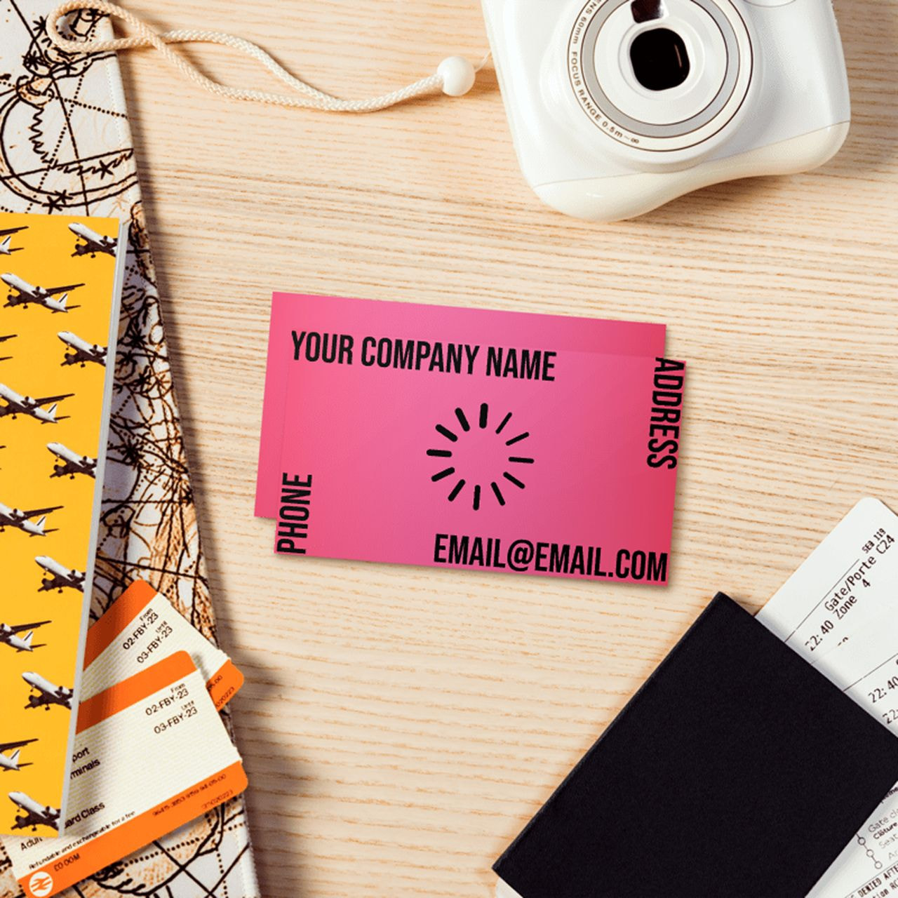 A camera, passport, and business cards arranged neatly on a table, suggesting travel and professional networking.