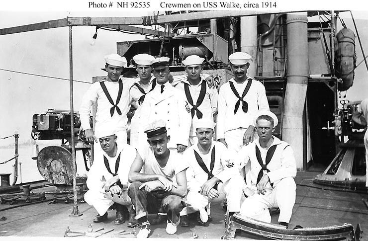 Eight sailors in white uniforms and hats on the deck of the USS Walke, circa 1914. 