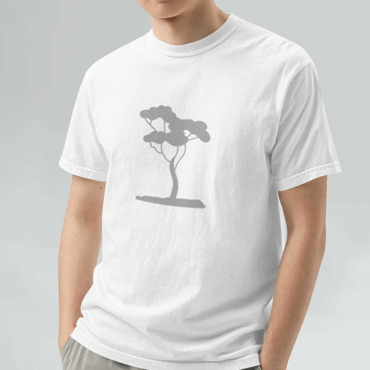 A man wearing a grey Unisex Garment-Dyed Heavyweight T-Shirt | Comfort Colors 1717 with a tree print in the middle