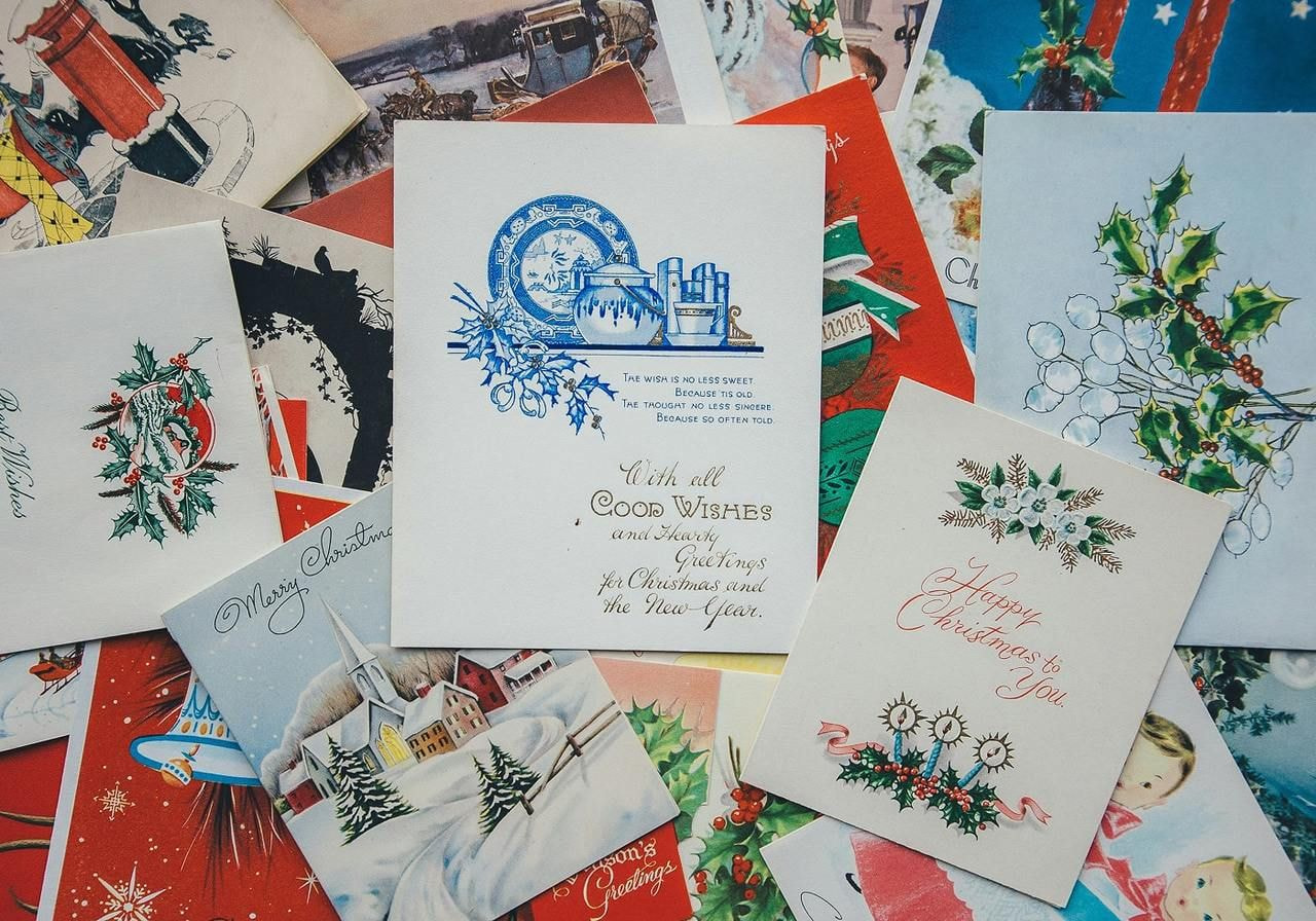 Various greeting cards are spread out on a table.